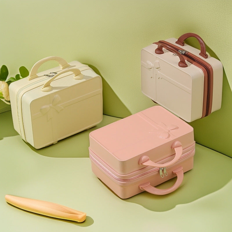 structured hard-shell cosmetic travel case with embossed bow and dual top handles Bowlift