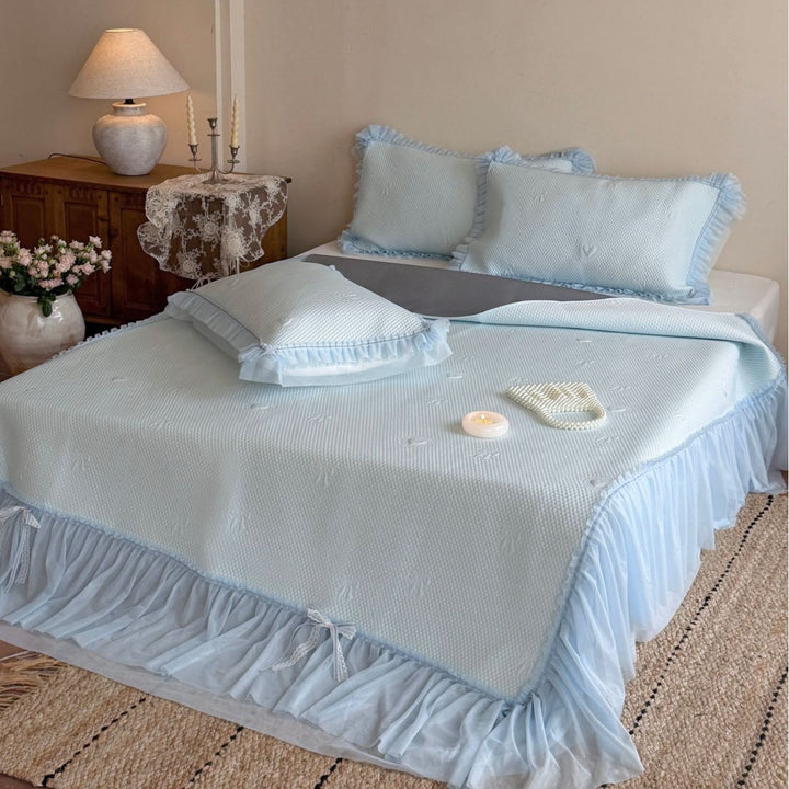Bedspread with pleated ruffle, waffle structure, and delicate heart quilting