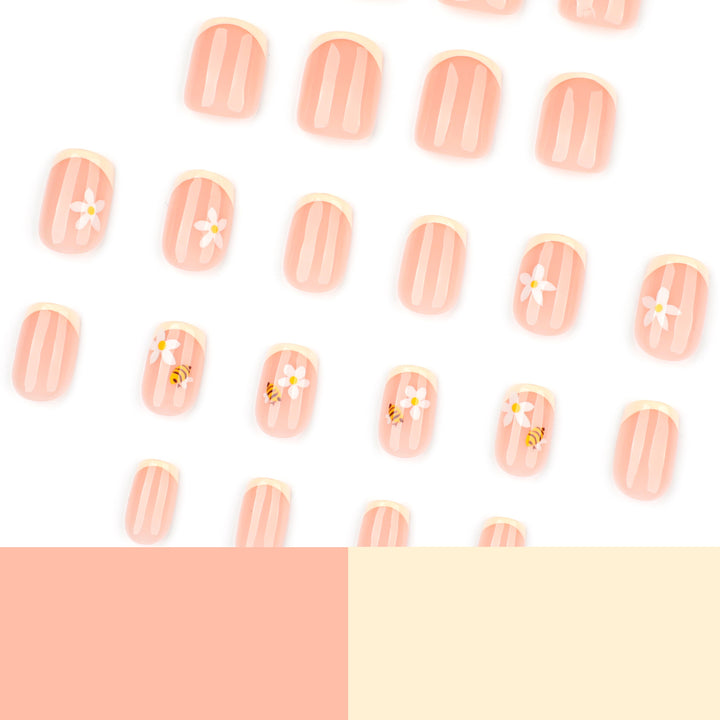 Artificial nail art with flower and bee motifs Bowlift