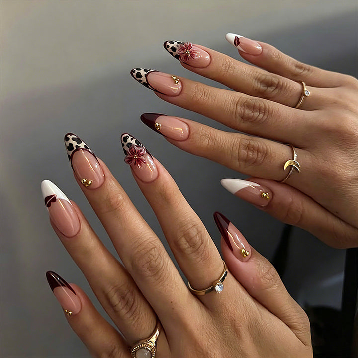 Artificial nail set with glamorous floral designs and creative glitter accents Bowlift