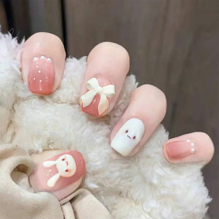 Glamorous artificial nails with heart design and glittering accents Bowlift
