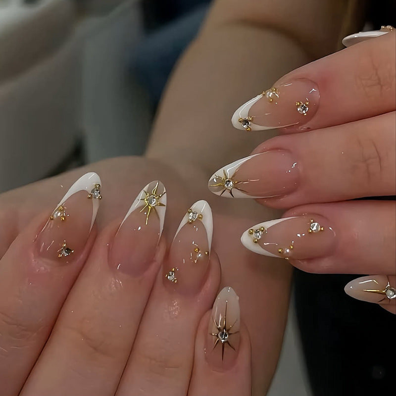 Glamorous nail art with rhinestones and gold accents Bowlift