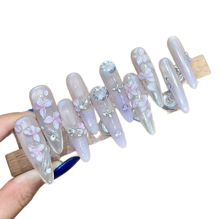 Artificial nails with delicate flower design and glitter accents Bowlift