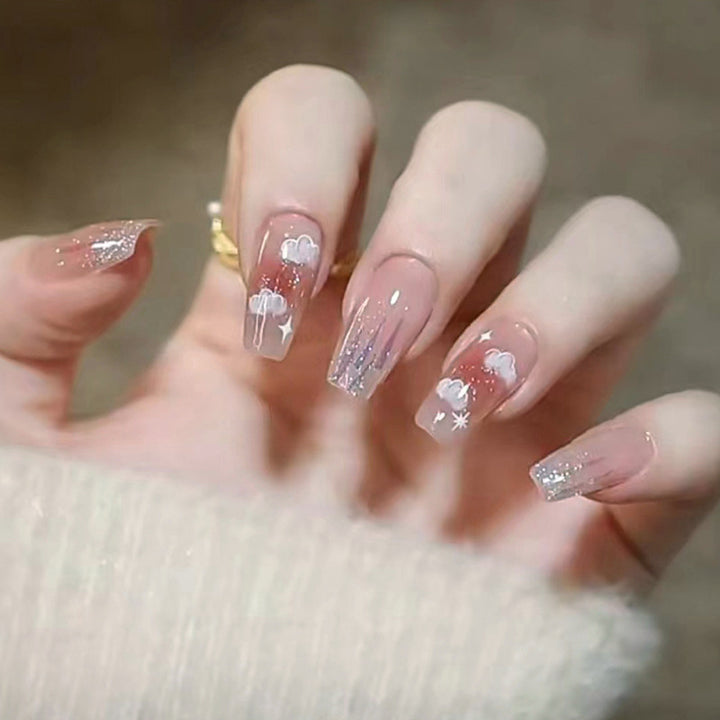 Artificial nail set with floral design and glitter accents Bowlift