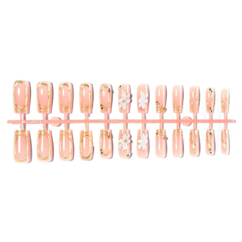 Elegant artificial nail set with decorative flower and gold embellishments Bowlift