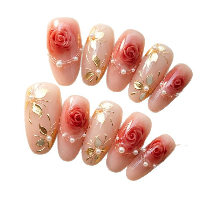 Artistic Nail Tips with Elegant Gold Jewelry Bowlift