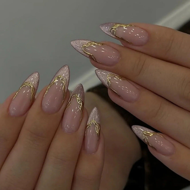 Acrylic nail set with glamorous tips and golden accents Bowlift