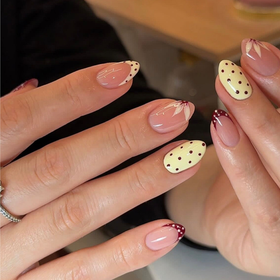 Artistic nail design with unique dots and floral embellishments Bowlift