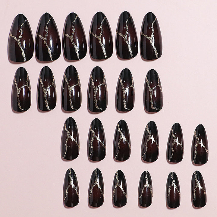 Artistic Press-On Nail Design with Gold Veining Accents Bowlift