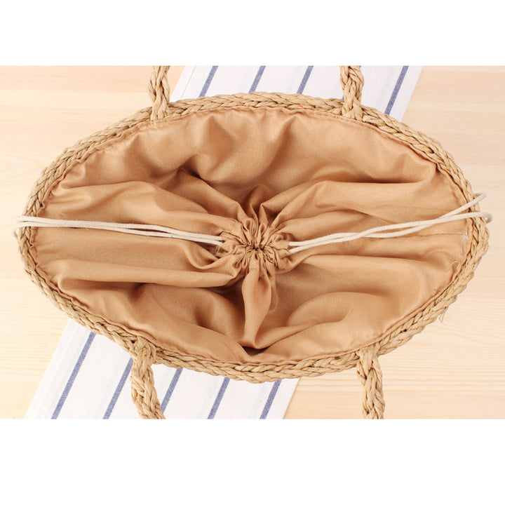 Braided handbag made of natural raffia with robust carrying straps Bowlift
