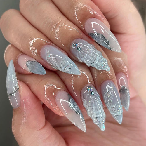 Artful stiletto nails with elegant glitter and floral design Bowlift