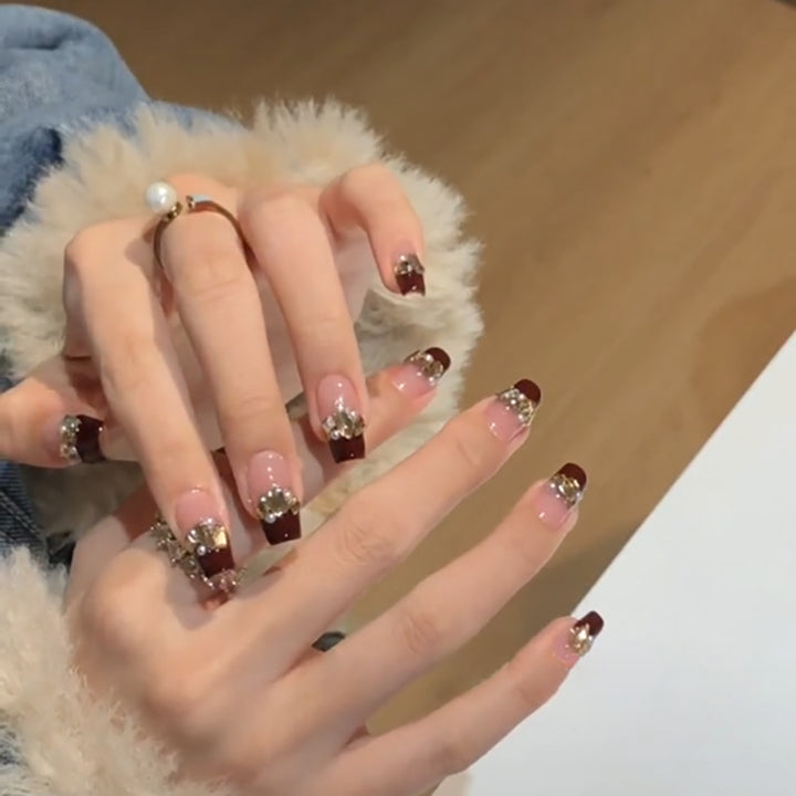Artful nail extensions with glitter and jewelry embellishments Bowlift
