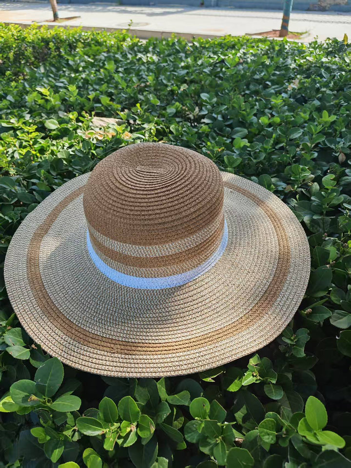 Elegant sun hat with wide brim and subtle stripe pattern Bowlift