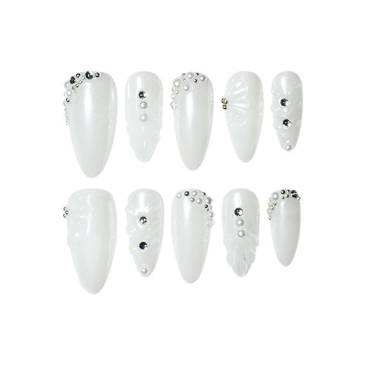 Elegant Stiletto Nail Enhancements with Decorative Pearls Bowlift