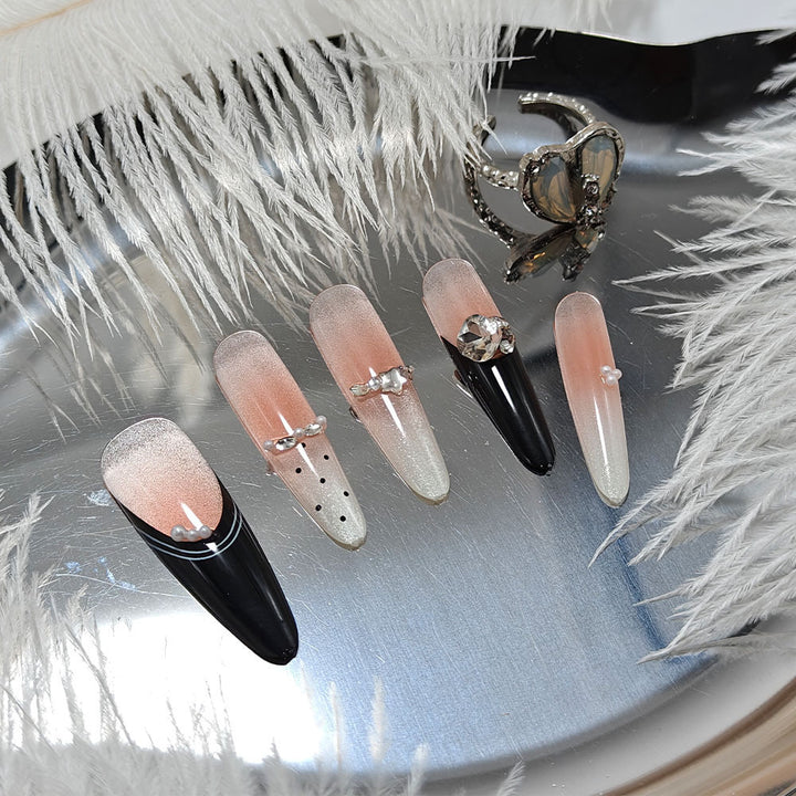 Artificial nails in elegant design with glittering decorations Bowlift