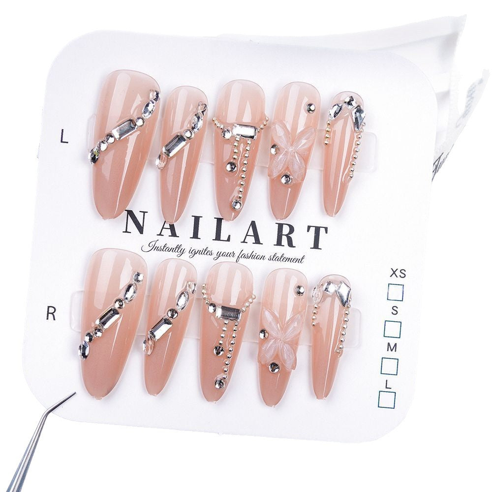 Artistic Press-On Nail Design with Floral and Glitter Accents Bowlift