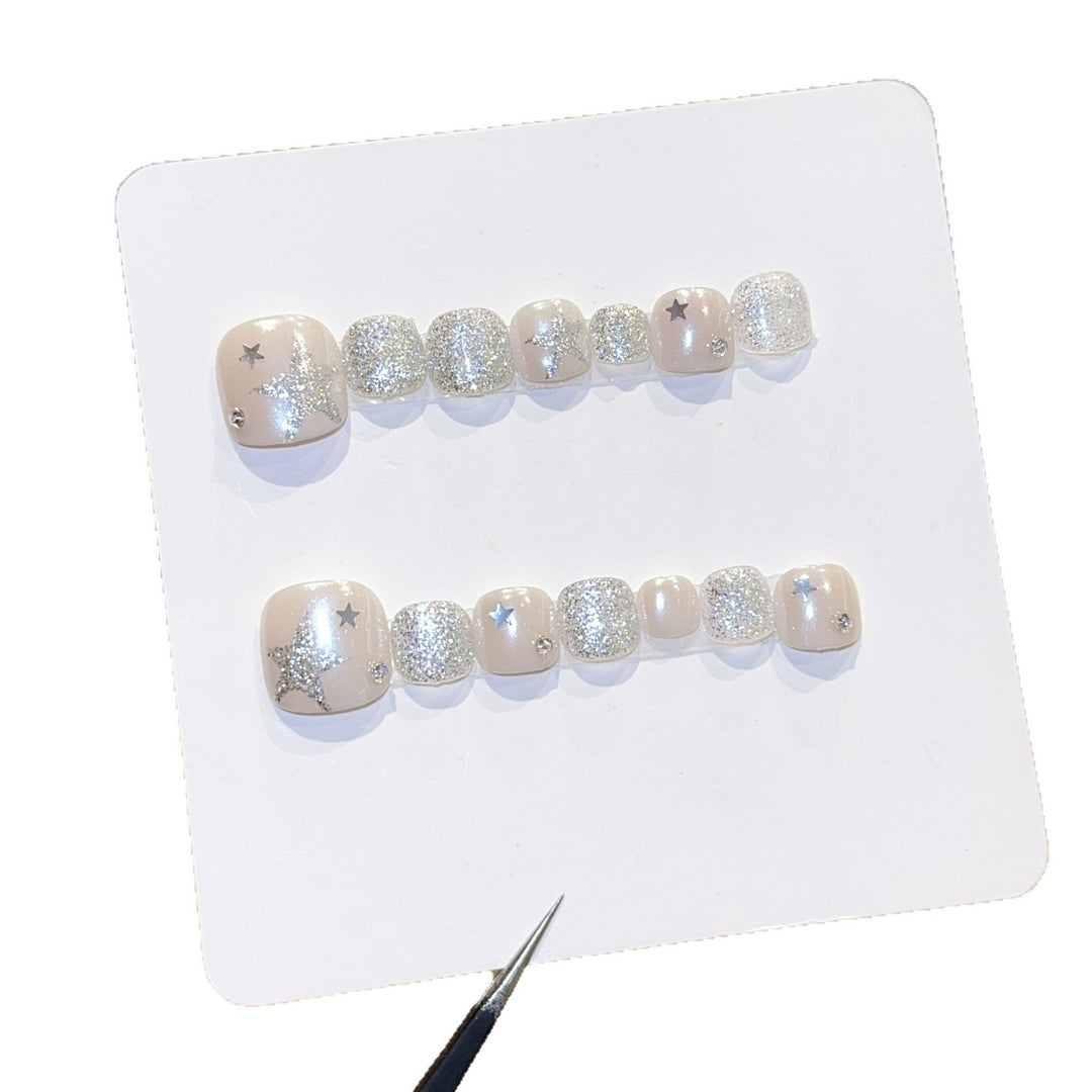 Glamorous artificial nails with sparkling stars and glitter accents Bowlift