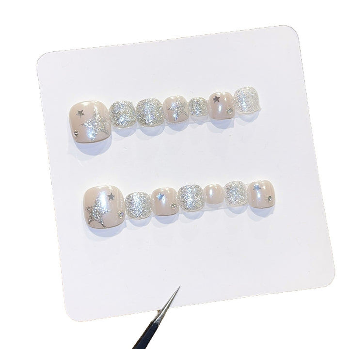 Glamorous artificial nails with sparkling stars and glitter accents Bowlift