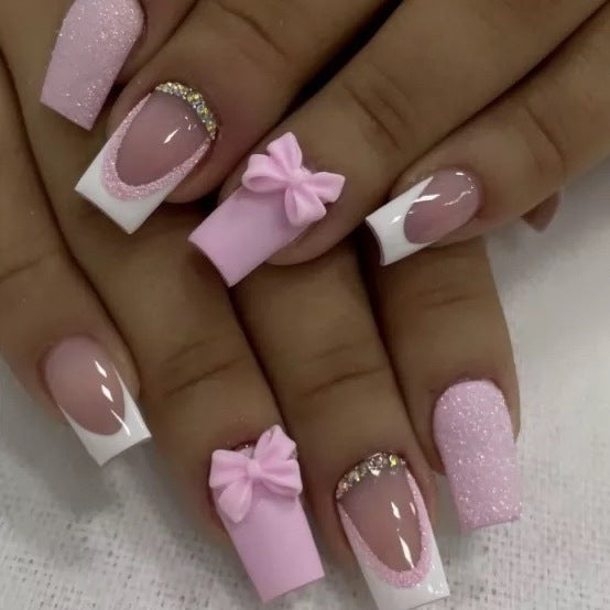 Artificial nail set with playful bows and glitter accents Bowlift