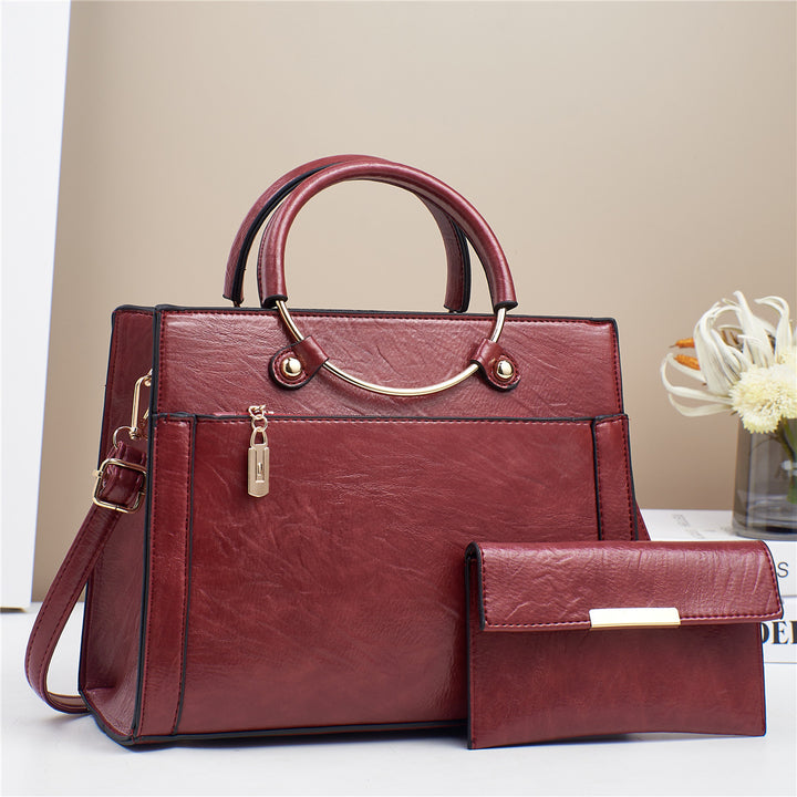 Elegant handbag with detachable shoulder strap and matching wallet Bowlift