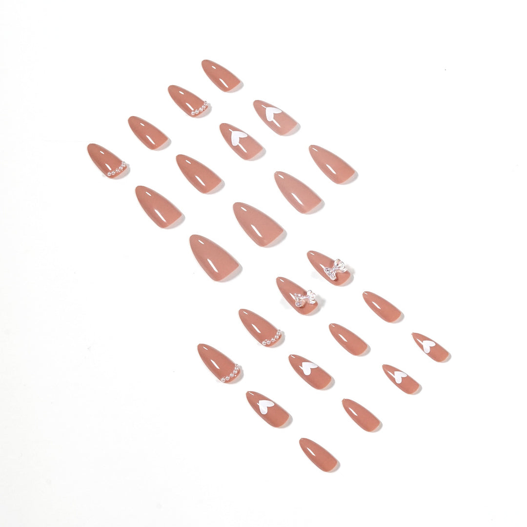 Elegant artificial nails with heart-shaped and glitter accents Bowlift