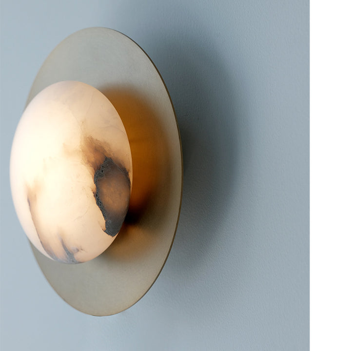 Contemporary alabaster globe wall sconce with round metal backplate Bowlift