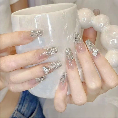 Artistic Nail Art with Glitter and Flower Applications Bowlift