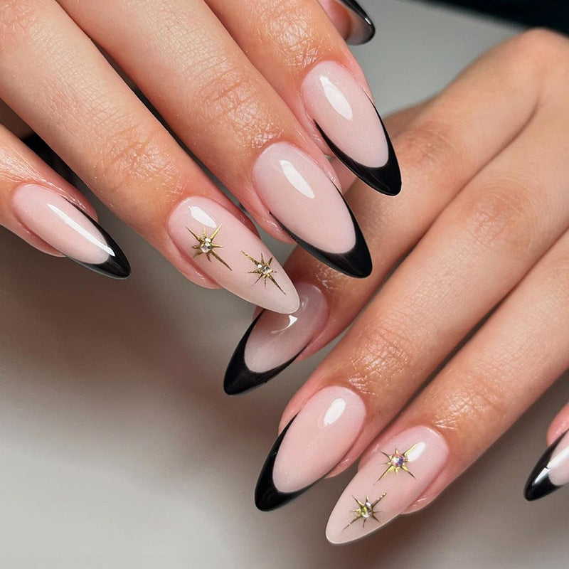 Artificial nail set with elegant black-and-white design and golden star accents Bowlift