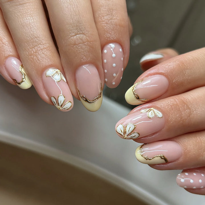 Artful Nail Extensions with Floral Design and Elegant Gold Accents Bowlift