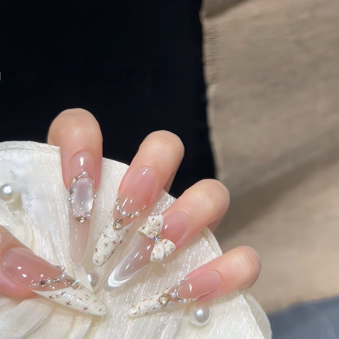 Artificial nails with elegant accents and rhinestone embellishments Bowlift