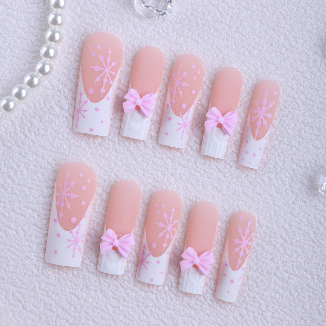 Artificial nail tips with playful bows and snowflake design Bowlift