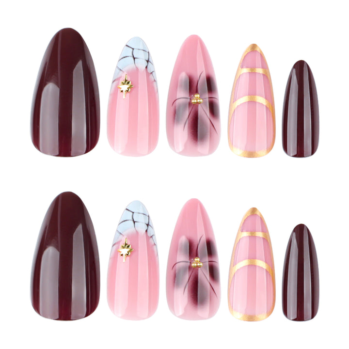 Artful Stiletto nails with gold accents and decorative floral designs Bowlift