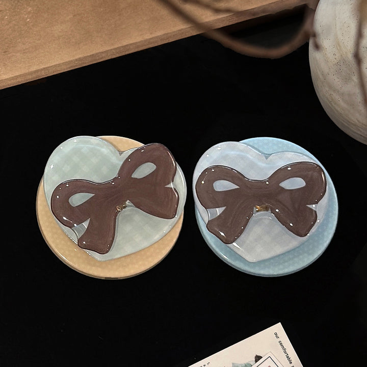 Decorative ceramic coaster with bow motif Bowlift