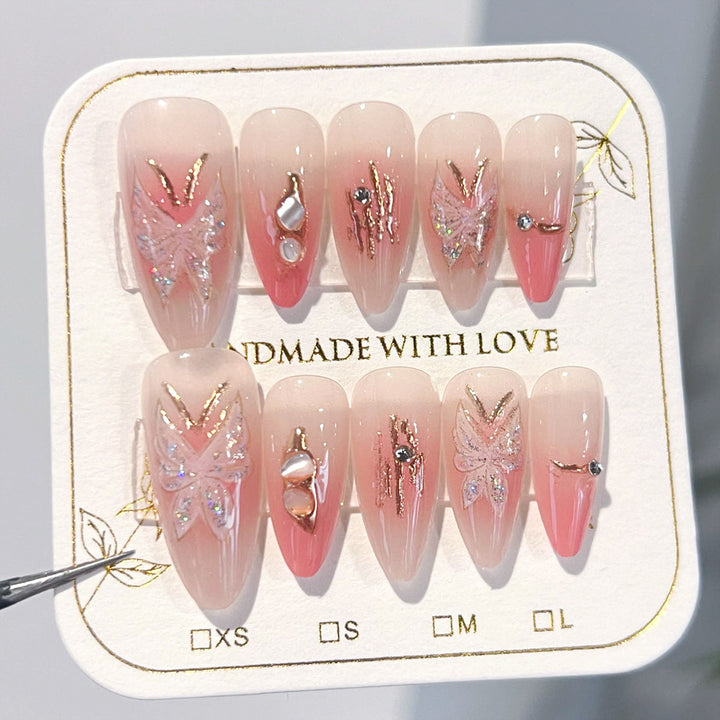 Artificial nail extensions with floral motifs and glitter accents Bowlift