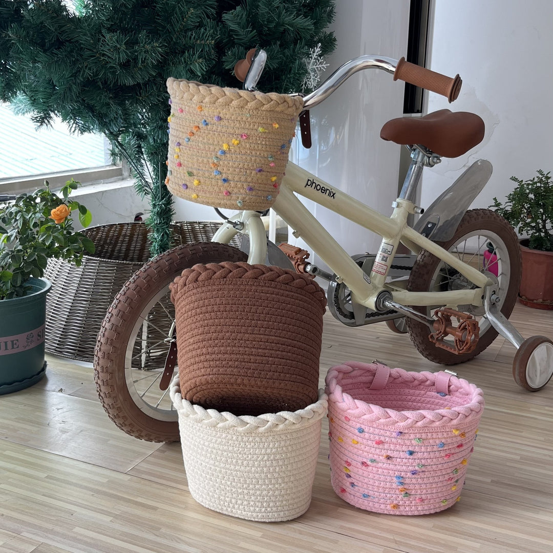 braided rope bike basket with pom pom embellishments and leather handlebar straps Bowlift