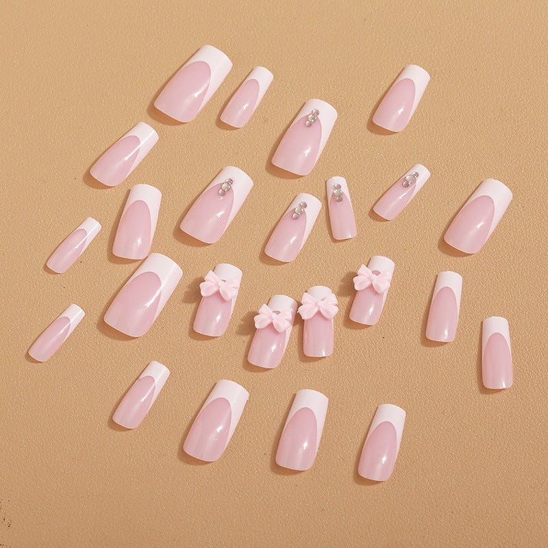 Trendy French-design artificial nails with bow accents Bowlift