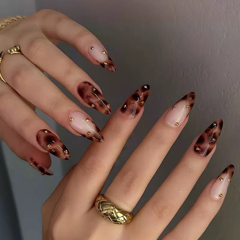 Acrylic nail set with luxurious leopard pattern and golden accents Bowlift