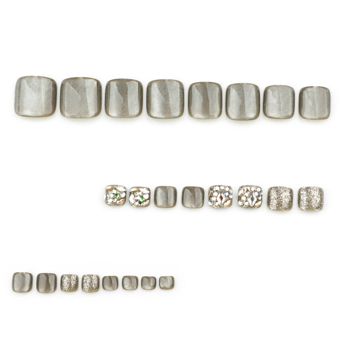 Artful toenail design with glitter and rhinestone decorations Bowlift