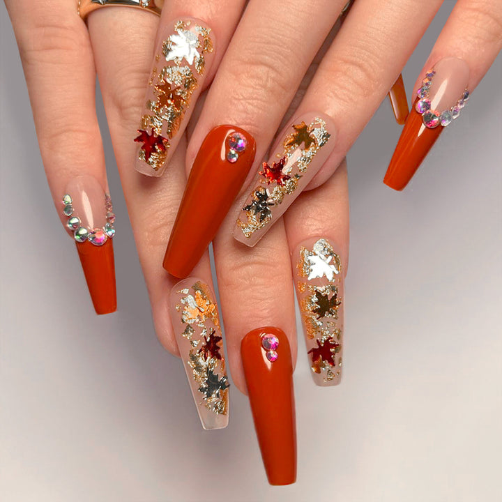 Glamorous acrylic nails with leaf design and glitter accents Bowlift