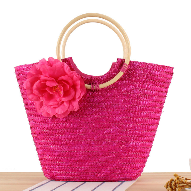 Braided straw bag with floral accent Bowlift