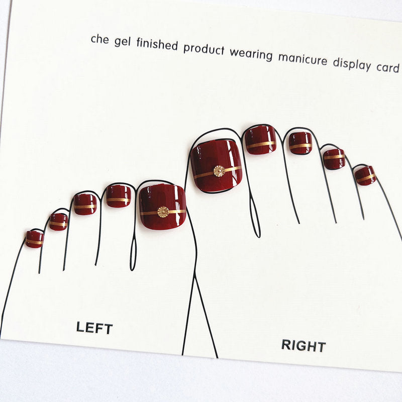 Artificial toenails with elegant gold embellishments Bowlift