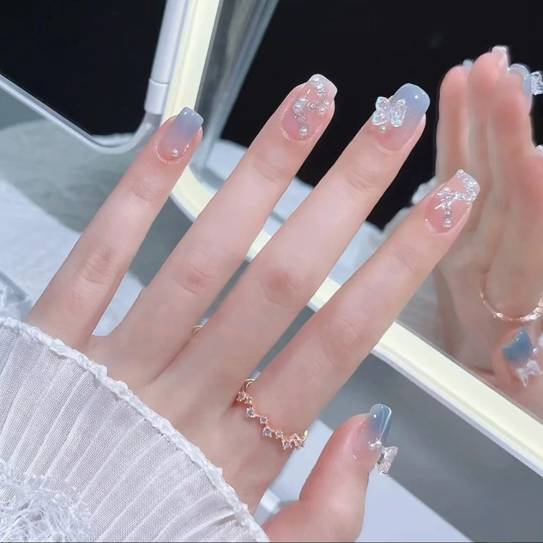 Artistic nail decoration with glitter and butterfly details Bowlift
