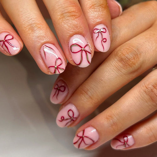 Artificial nail design with bow motifs Bowlift