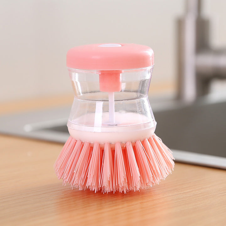 Dish brush with soap dispenser for pressing