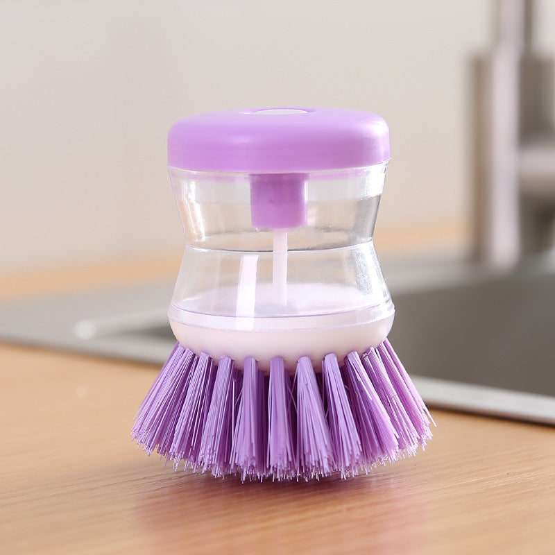Dish brush with soap dispenser for pressing