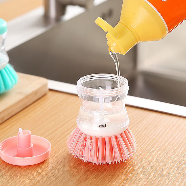 Dish brush with soap dispenser for pressing