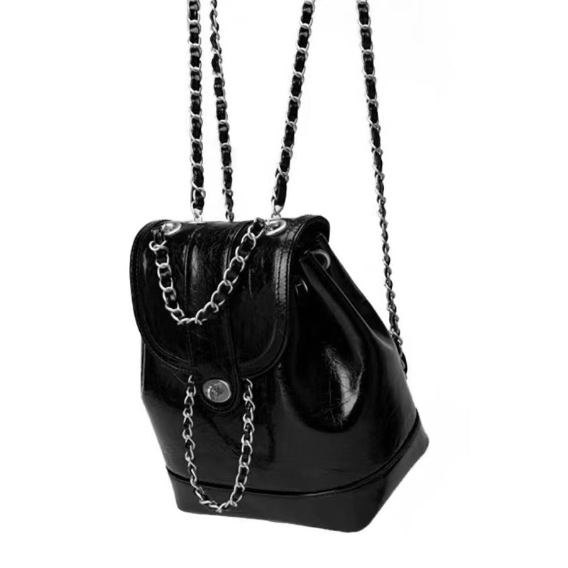 Compact backpack made of PU with chain decoration
