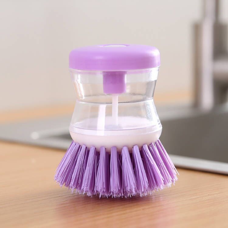 Dish brush with soap dispenser for pressing