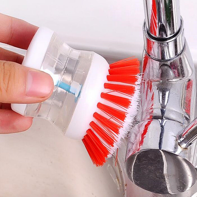 Dish brush with soap dispenser for pressing