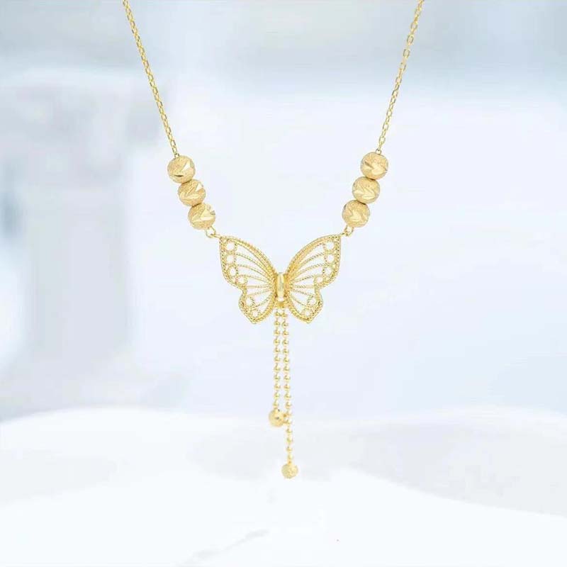 BowLift | Necklace with gold-colored butterfly with tassels
